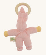 Back view of the pink Nanchen Pimpel Doll showing the soft texture of the organic cotton terry fabric, knotted feet, and the wooden teething ring looped through the pointed hat.