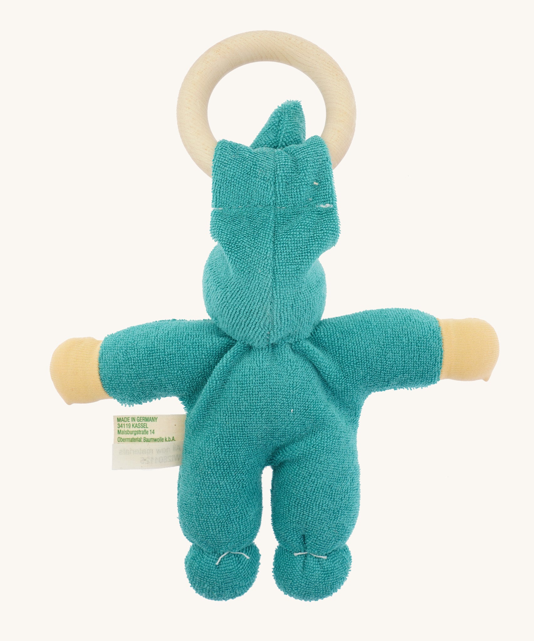 Back view of the turquoise Nanchen Pimpel Doll highlighting the gathered seams, soft organic cotton terry material, and light wooden ring for teething.
