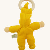 Back view of the yellow Nanchen Pimpel Doll, displaying the curved back stitching, rounded limbs, and how the wooden ring is held in place by the fabric hat.
