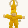 Front view of the Nanchen Pimpel Doll Baby Comforter in bright yellow, with a sweetly painted Waldorf-style face and wooden teething ring attached by its hat. The body and limbs are plush and rounded for cuddling.