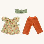 The Nanchen organic Waldorf doll Flore's removable outfit - a floral top, orange corduroy trousers, and a green hair bow.