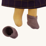 A closeup of the Nanchen organic Waldorf doll Marlene, showing her removable lilac boots.