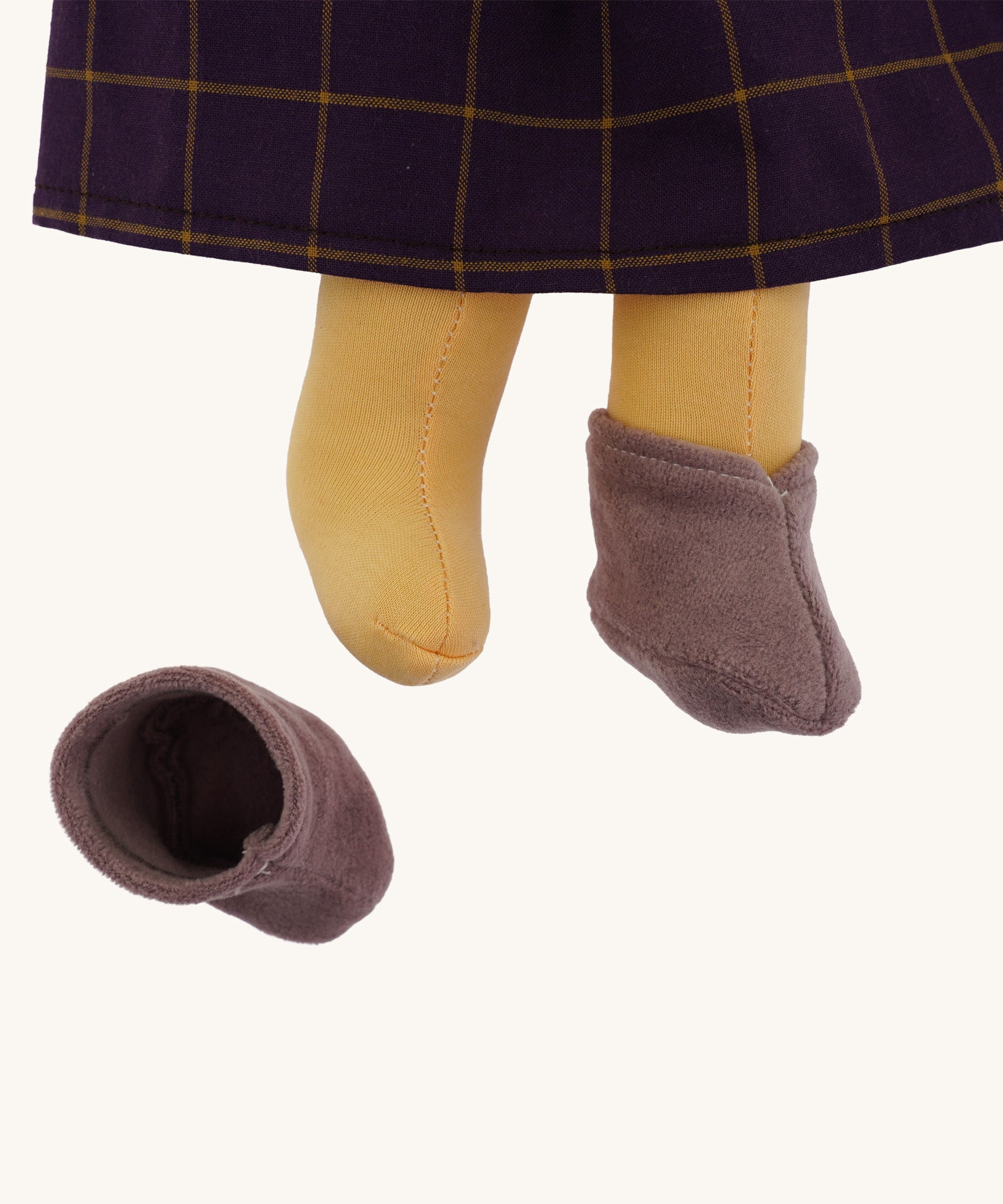 A closeup of the Nanchen organic Waldorf doll Marlene, showing her removable lilac boots.