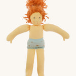 The Nanchen 'Marlene' organic Waldorf doll with curly red hair, with her clothes taken off and only wearing her blue underwear.