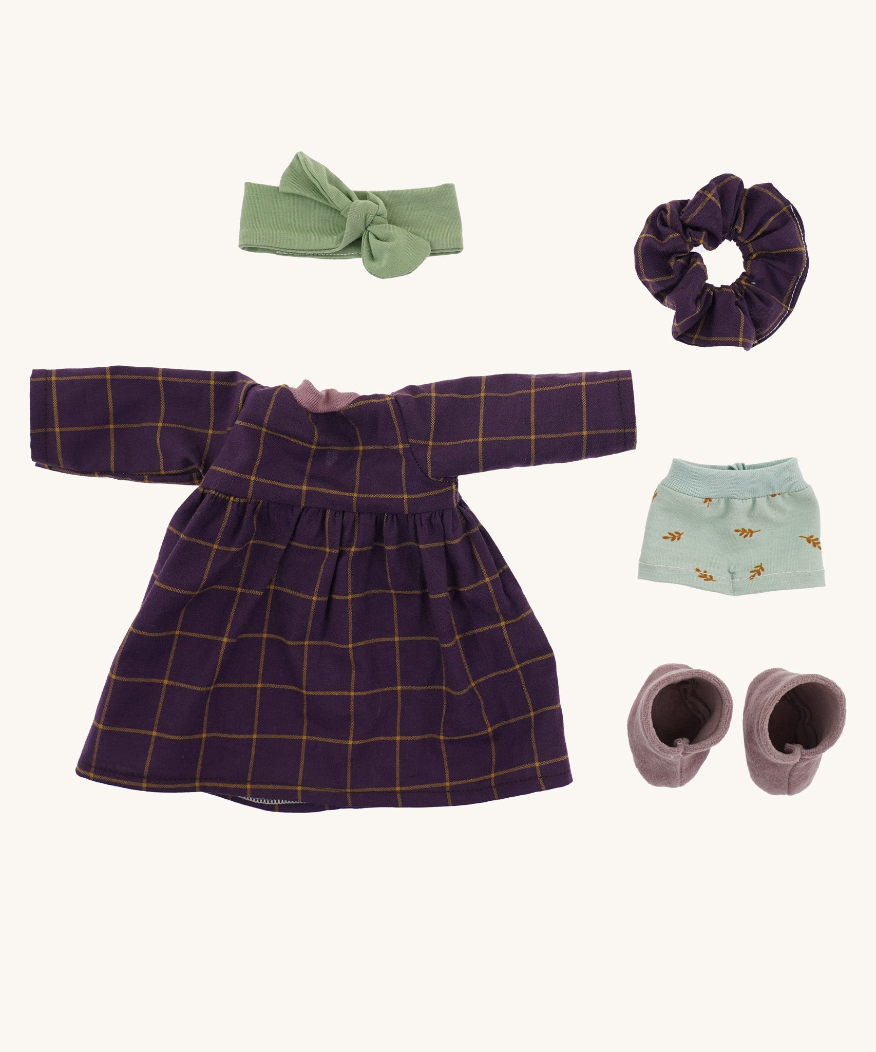 Marlene's removable outfit - a purple patterned dress, a matching scrunchie, a green hair bow, lilac boots, and blue underwear