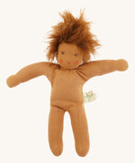 Full view of the same Nanchen organic Waldorf doll with brown skin and tousled brown hair, shown unclothed to highlight the soft fabric body.
