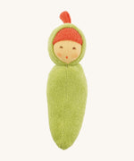 Front view of the Nanchen Pea Pod Rattle Doll, featuring a soft green organic cotton body shaped like a pea pod. The doll has a round hand-painted face with rosy cheeks and a red terry top knot, peeking from a hooded design.