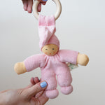 A pink Nanchen Pimpel Waldorf Doll Ring Comforter in an adult's hands.
