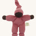 A Nanchen Pimpel Waldorf Handcrafted Doll with a berry pink coloured outfit an matching knotted hat. The doll has dark brown coloured skin. 