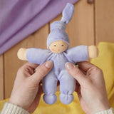 Nanchen Natur Pimpel Waldorf doll in lavender in an adult's hand in the Babipur playroom