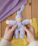Nanchen Natur Pimpel Waldorf doll in lavender in an adult's hand in the Babipur playroom