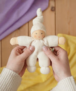 Nanchen Natur Pimpel Waldorf doll in natural in an adult's hands in the Babipur playroom. 