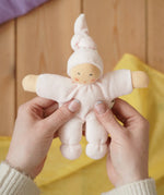 Nanchen Natur Pimpel Waldorf doll in pastel pink in an adult's hands in the Babipur playroom. 