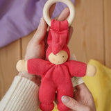 Cherry red Nanchen Pimpel Waldorf Doll Ring Comforter in an adult's hands. 