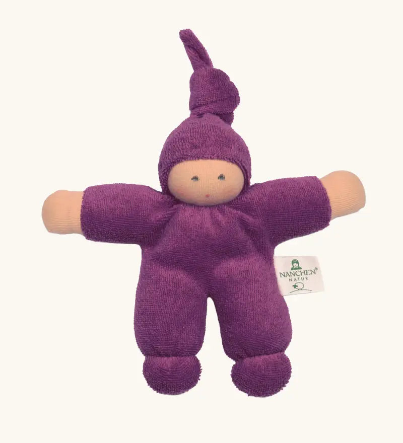 Nanchel pimpel waldorf doll in purple. Showing cute facial features and a tie on the hat. Doll has a terry cloth body 
