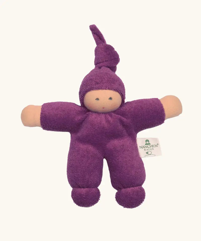 Nanchel pimpel waldorf doll in purple. Showing cute facial features and a tie on the hat. Doll has a terry cloth body 