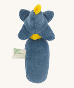 The back of the Nanchen Flower Rattle Doll - Forget-Me-Not, this is a soft, organic and handmade sensory doll toy with a blue body, a little blue hat with blue forget-me-not leaves and a yellow strip of fabric to mimic hair. This doll also has an adorable face with blue eyes