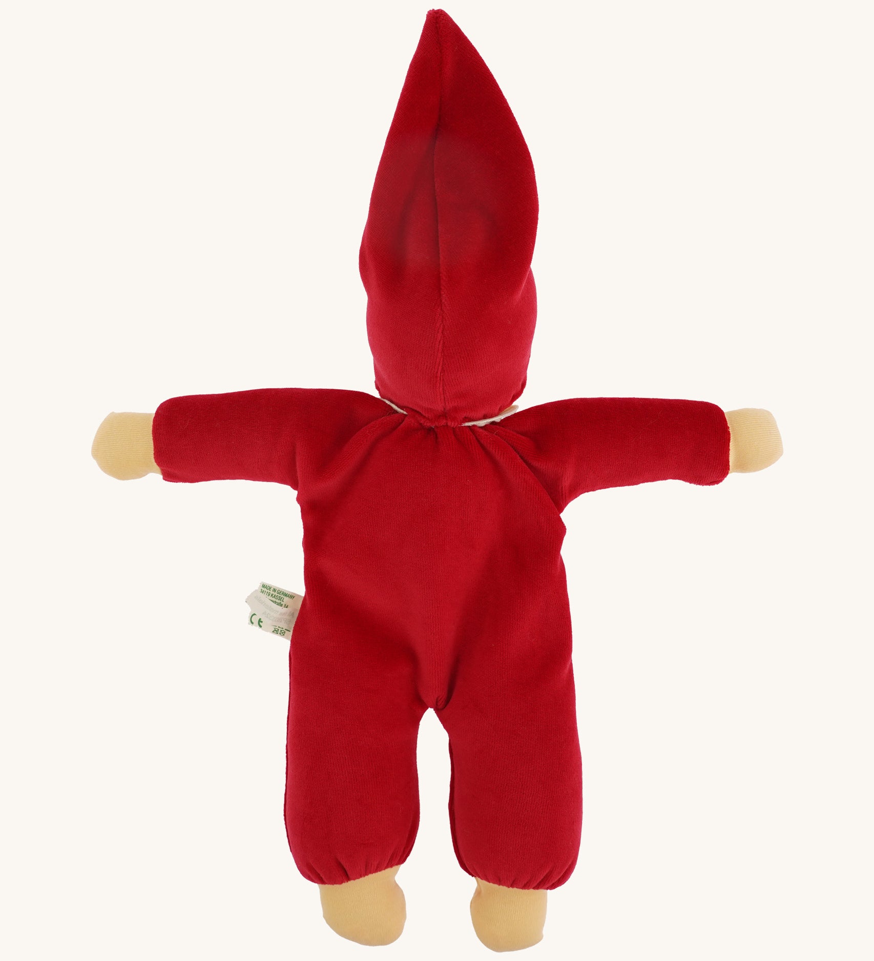 The back of the Nanchen Waldorf Nani Doll This hand crafted doll toy has a red fabric, soft body with a small white collar and red pointy hat. On a cream background