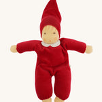 A beautiful Nanchen Waldorf Nani Doll, with a pretty hand painted face. This hand crafted doll toy has a red fabric, soft body with a small white collar and red pointy hat. On a cream background