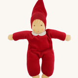 A beautiful Nanchen Waldorf Nani Doll, with a pretty hand painted face. This hand crafted doll toy has a red fabric, soft body with a small white collar and red pointy hat. On a cream background
