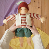 Nanchen Natur dress-up Waldorf doll chestnut child Karlotta in an adults hands in the Babipur playroom.