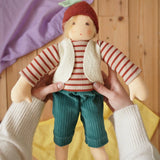 Nanchen Natur dress-up Waldorf doll chestnut child Paul in an adult's hands in the Babipur playroom.