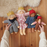 Four Nanchen organic Waldorf dolls, King Karl, Rossi and apple children placed on a wooden floor in the Babipur playroom. 