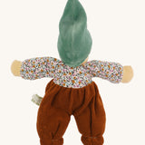 The back of the Nanchen Forest Child Waldorf Doll - Sage. This beautifully handcrafted doll wears sage velour trousers, a brown hat and a floral top. On a cream background