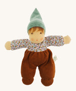 Nanchen Forest Child Waldorf Doll - Sage. This beautifully handcrafted doll wears sage velour trousers, a brown hat and a floral top. On a cream background