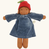 Nanchen Lenne garden child waldorf doll showing a blue terry cloth, long sleeve dress and red apple hat. 