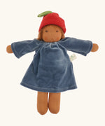 Nanchen Lenne garden child waldorf doll showing a blue terry cloth, long sleeve dress and red apple hat. 