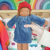 Adult hand holding a Nanchen Lenne garden child waldorf doll showing scale