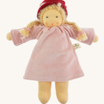 Nanchen Gardenchild Doll, Lolle is a beautiful handcrafted Waldorf doll toy. With a light pink dress, an adorable hand painted face with blue eyes, blonde hair in two braids each secured with red ribbons, and a red and white mushroom style hat. On a cream background
