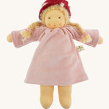 Nanchen Gardenchild Doll, Lolle is a beautiful handcrafted Waldorf doll toy. With a light pink dress, an adorable hand painted face with blue eyes, blonde hair in two braids each secured with red ribbons, and a red and white mushroom style hat. On a cream background