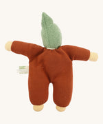 Back view of the Nanchen Walnut Baby Doll, displaying its rust-colored cotton terry body and knitted green pointed hood. The doll’s arms are outstretched and the natural cotton tag is visible on the side.