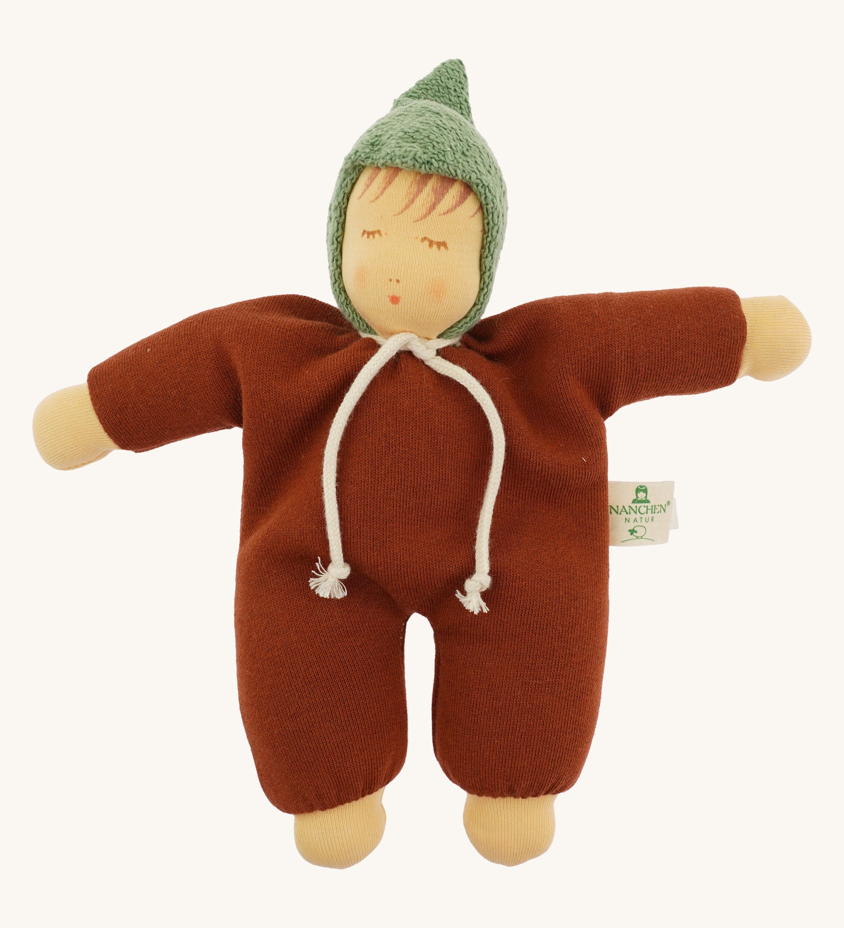 Front view of the Nanchen Waldorf Walnut Baby Doll. The doll wears a warm brown organic cotton terry suit with a green pointed hood and a white tie at the neck. Its soft face features hand-painted sleeping eyes, rosy cheeks, and a small pink mouth.
