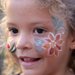 Young girl with a colourful Natural Earth face paint pattern around her eye