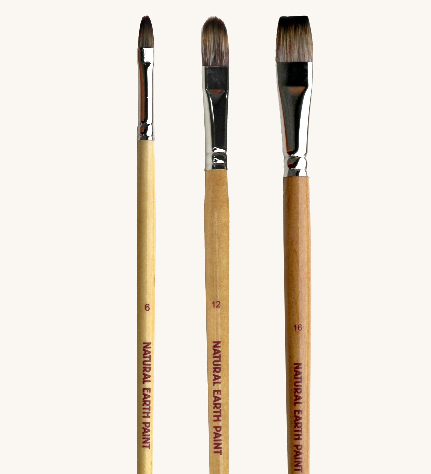 A set of 3 Natural Earth Paint brushes. Features a wooden handle and in sizes 6, 12 and 16. Brand name printed on the side of the brush