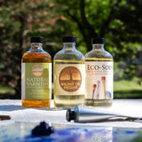 Natural Earth Paint natural varnish next to the walnut oil jar and brush cleaner on a table in the garden