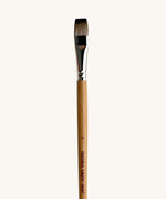 A close up view of the size 16 Natural Earth paint brush showing the wooden handle and brand name printed on the side