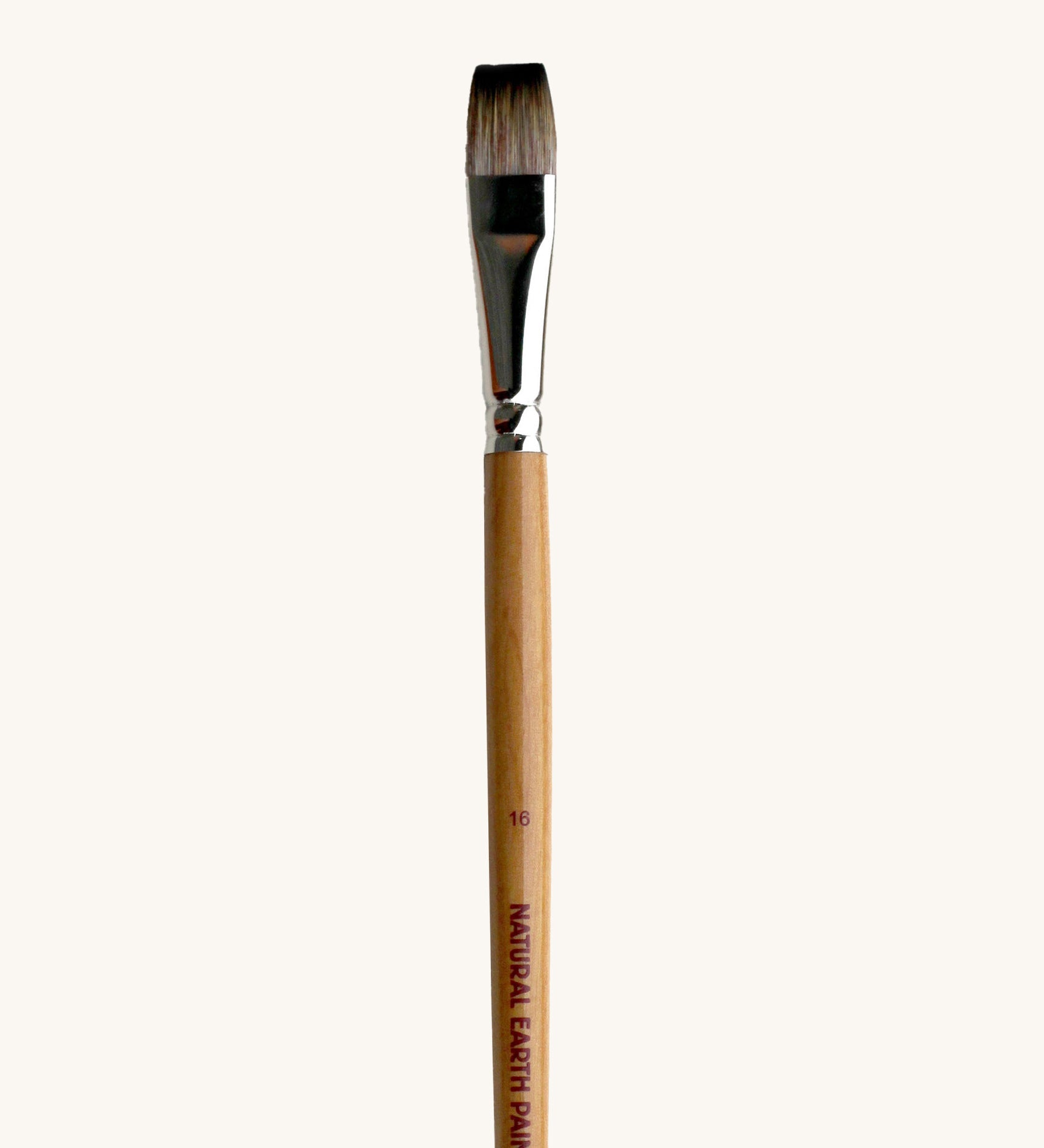 A close up view of the size 16 Natural Earth paint brush showing the wooden handle and brand name printed on the side