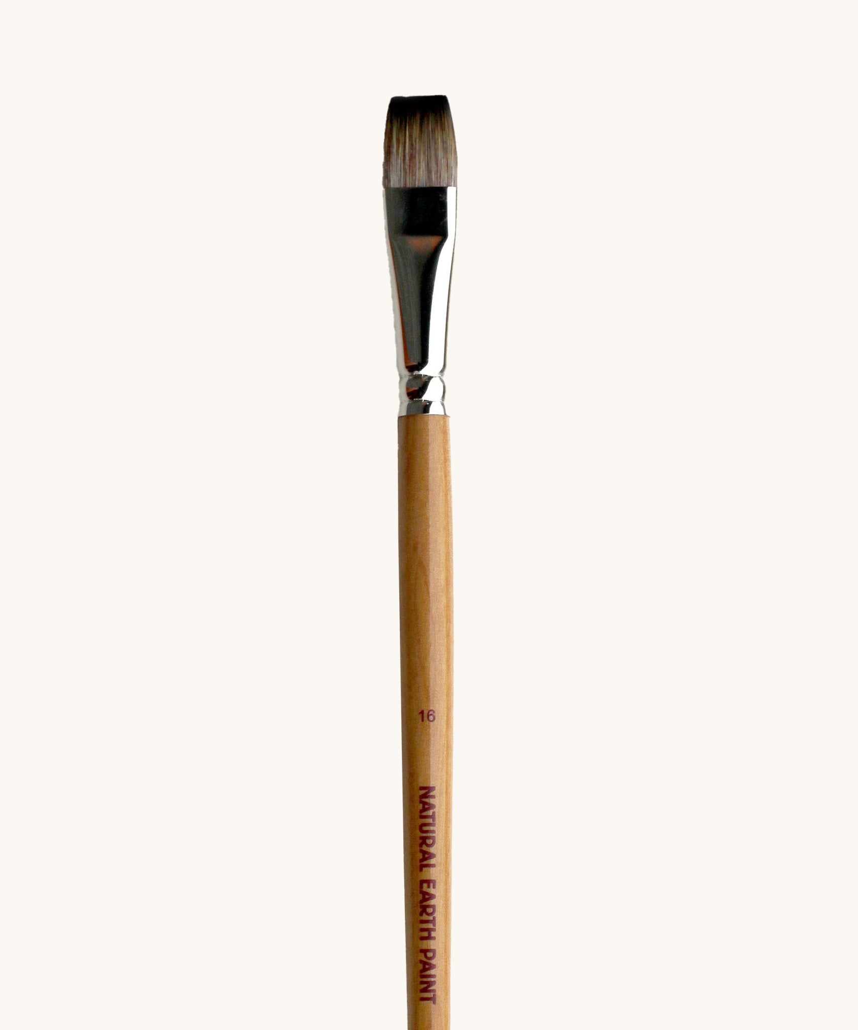 A close up view of the size 16 Natural Earth paint brush showing the wooden handle and brand name printed on the side