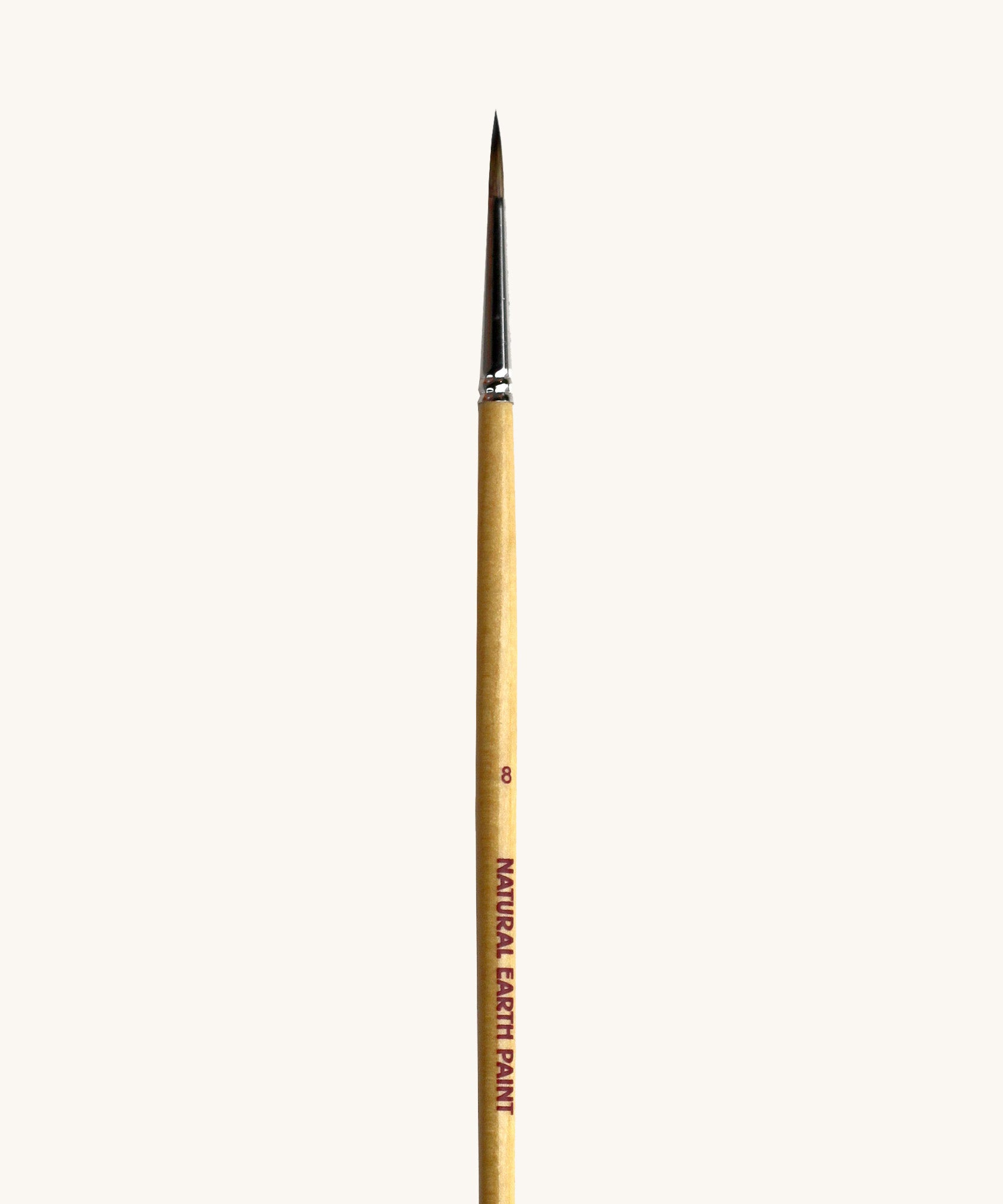 A close up view of the size 8 Natural Earth paint brush showing the wooden handle and brand name printed on the side