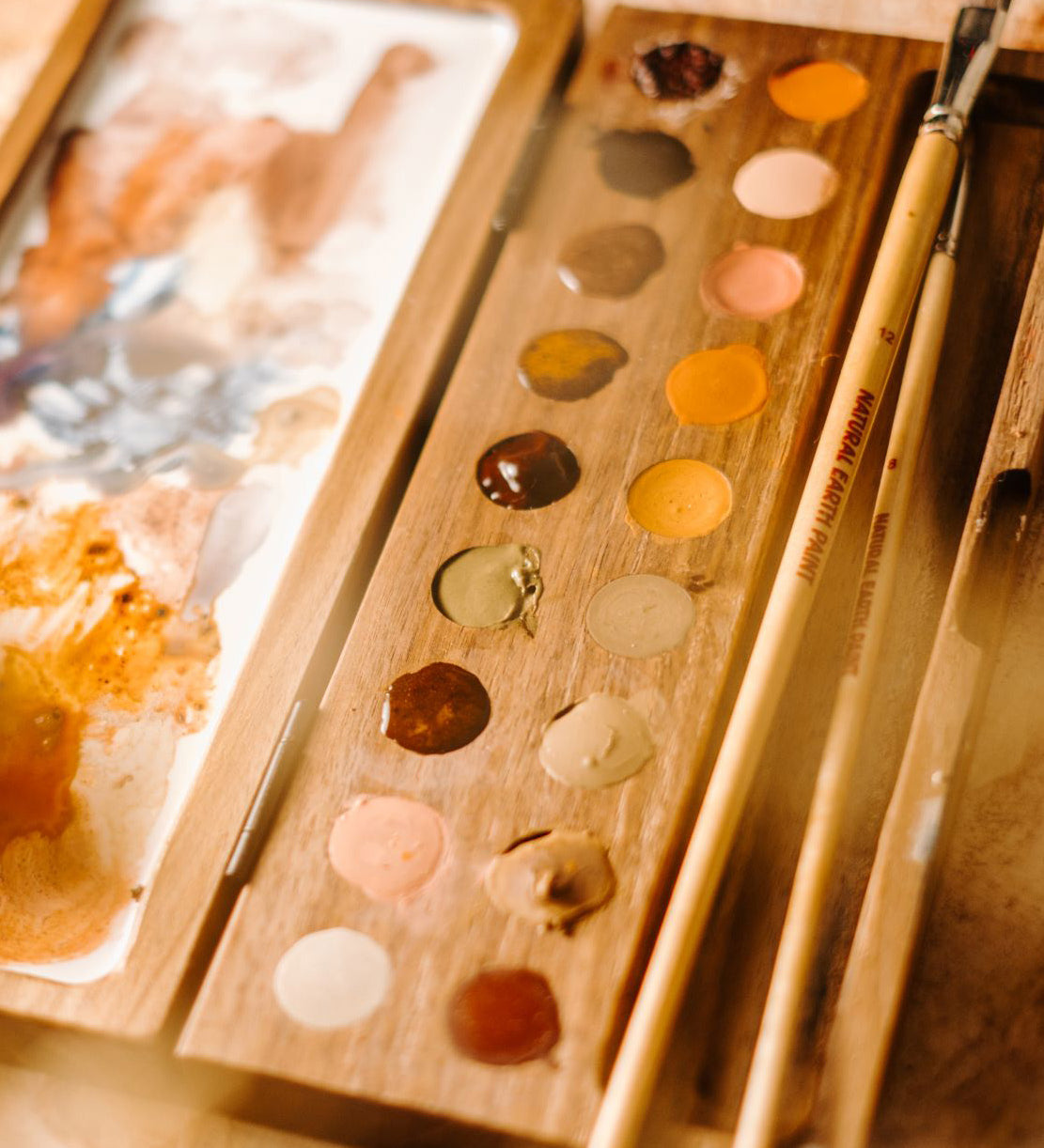 Natural Earth Paint wooden watercolour palette with brush holder features 18 holes for paint, a mixing panel and a brush holder