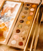 Natural Earth Paint wooden watercolour palette with brush holder features 18 holes for paint, a mixing panel and a brush holder