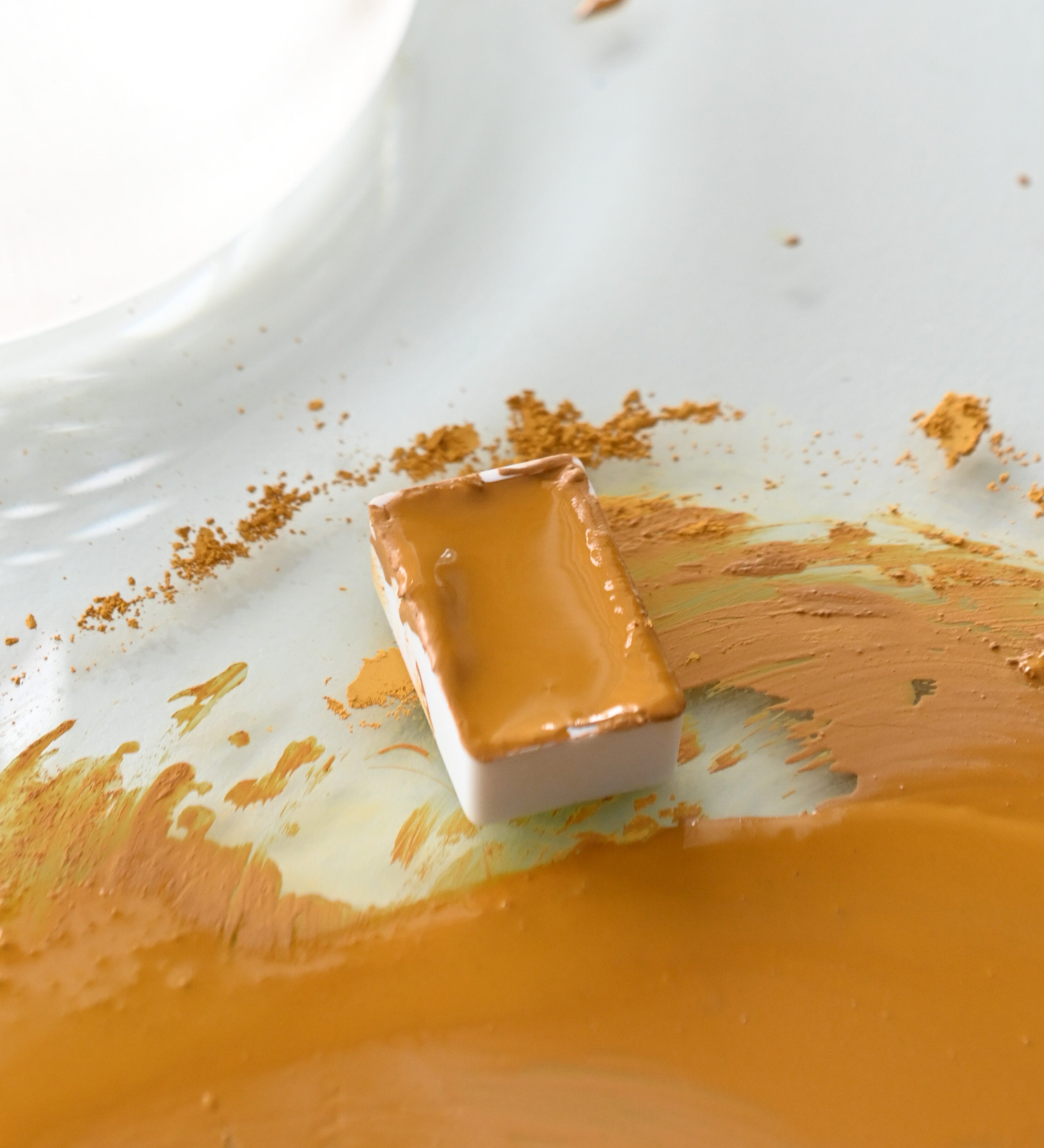 Natural Earth Paint watercolour pan filled with mustard yellow paint