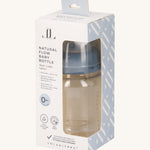 The Lola & Lykke Natural Flow Baby Bottle with cap, inside it's packaging. The packaging has a cut out so you can see the bottle inside