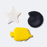 A child playing with the yellow fish bath toy from the Etta Loves Natural Rubber Animal Sensory Bath Toys - 3 Pack