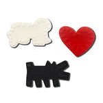 A child playing with the 'Baring Dog' bath toy from the Etta Loves X Keith Haring Natural Rubber Sensory Bath Toys - 3 Pack