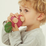 A child holding the Oli & Carol 100% Natural Rubber Car collection